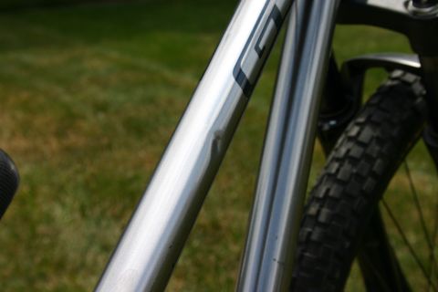 1997 Ford Probe - A close-up view of a dented bicycle frame with a knobby tire visible.