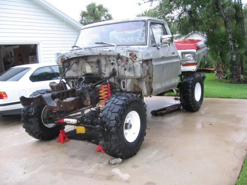 1974 Ford F-100 - This 1974 Ford F-100 pickup is shown on jack stands with its chassis exposed, indicating a project or repair in-progress repair.