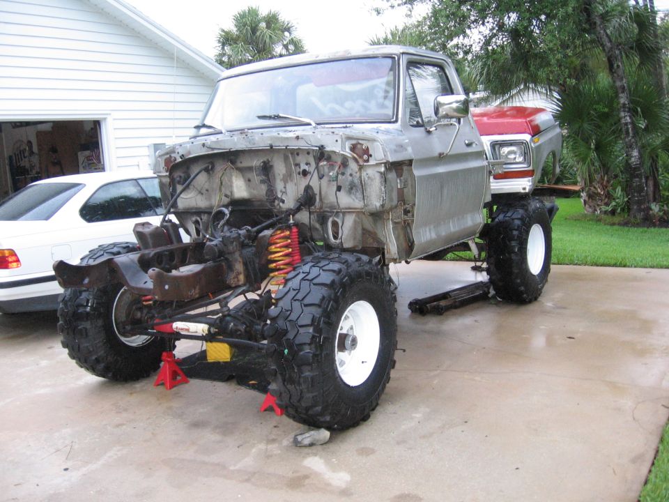 1974 Ford F-100 chassis on jacks, front view. Another cab visible behind