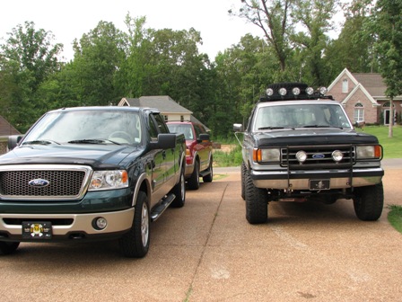 1991 Ford Bronco - A 1991 Ford Bronco is parked on a driveway next to a newer model truck.
