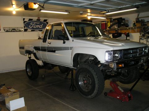 1986 Toyota Hilux - This 1986 Toyota Hilux pickup truck is shown in a garage, elevated on jack stands for suspension work.