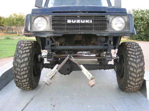 1987 Suzuki Samurai - Front view of a 1987 Suzuki Samurai showing the grille and suspension components.