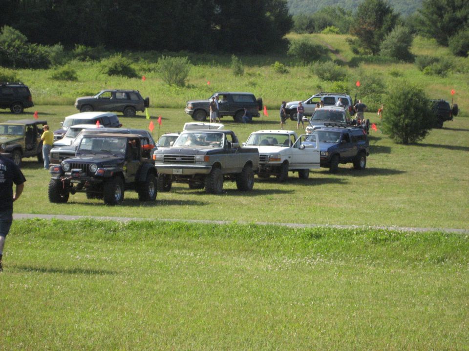 Gray Ford F-Series pickup truck with a dark grille, parked on grass