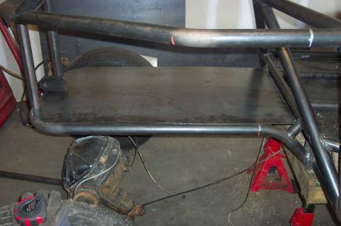 1992 Ford Mustang - The chassis and roll cage are under construction, with a rear axle visible.