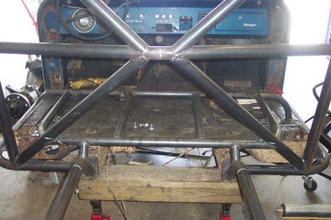 1992 Ford Mustang - The interior of a vehicle is visible, showing a roll cage installation and a blue dashboard.