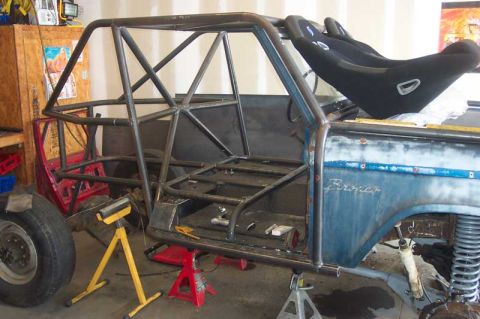 1992 Ford Mustang - A blue Ford Bronco is shown with a custom roll cage and racing seats installed, indicating a significant build-up project.