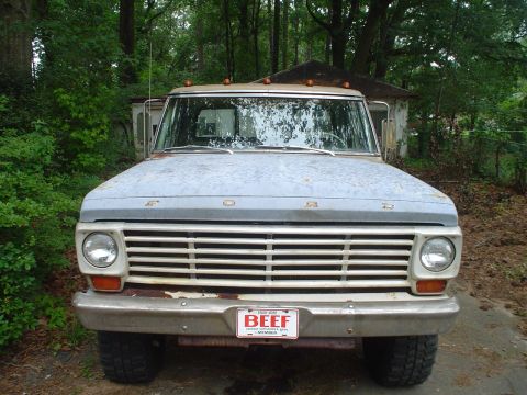 1967 Ford F-250 - Frontal view of a 1967 Ford F-250 truck parked outdoors with trees in the background.