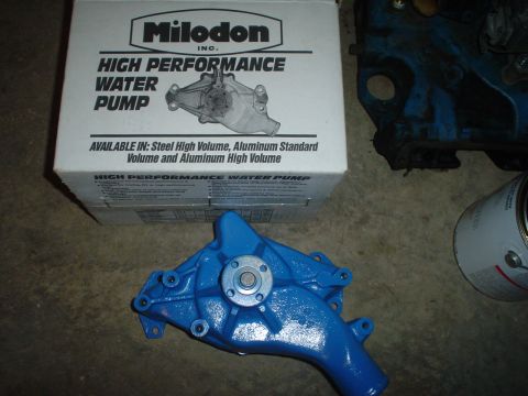 1967 Ford F-250 - A blue water pump sits on the floor next to its Milodon High Performance Water Pump box.