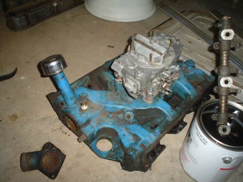 1967 Ford F-250 - Engine block with carburetor and associated parts, likely for a vintage vehicle.