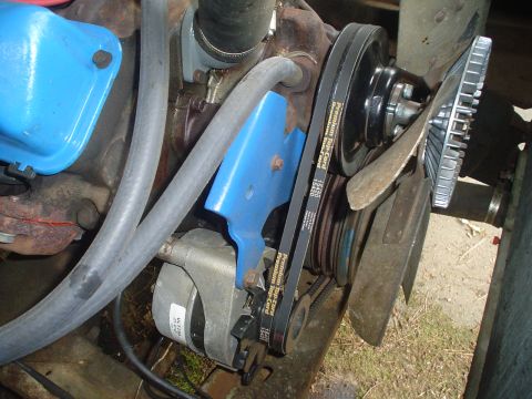1967 Ford F-250 - Close-up view of engine components including belts, pulleys, and a fan.