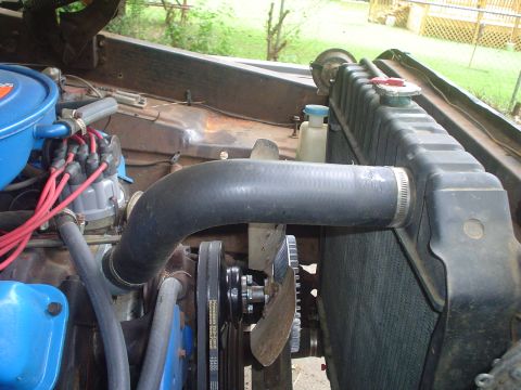 1967 Ford F-250 - Close-up view of the engine compartment of a 1967 Ford F-250, highlighting the radiator and fan assembly.