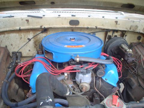 1967 Ford F-250 - Close-up view of a vehicle's engine bay, showing the air filter housing and ignition system.