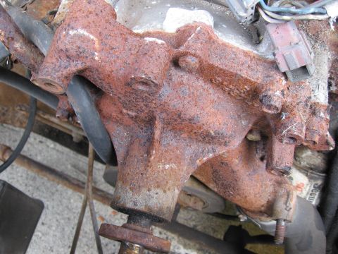1974 Ford F-100 - Close-up of a corroded engine part, likely from an older vehicle.
