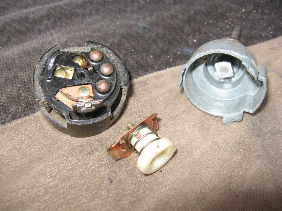Disassembled ignition switch components including the switch body, housing, and actuator