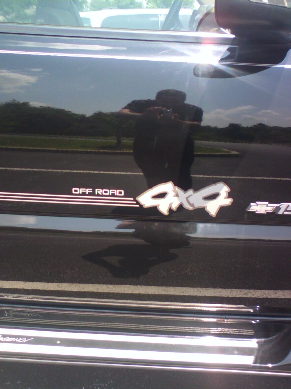 Off Road 4x4 decal on the glossy black bedside of a Chevrolet truck