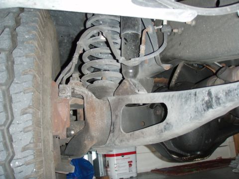 1996 Ford Bronco - The undercarriage of a 1996 Ford Bronco shows its suspension components and tire.