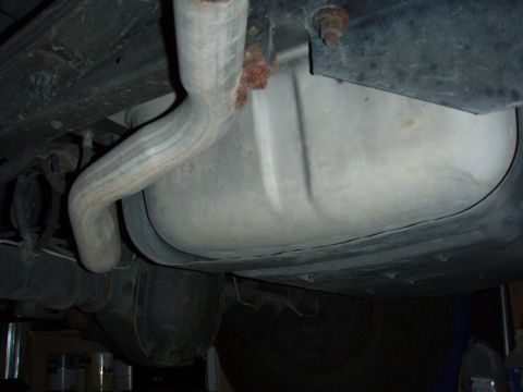 1996 Ford Bronco - A view of the undercarriage, showing the exhaust system and fuel tank, with some signs of rust.