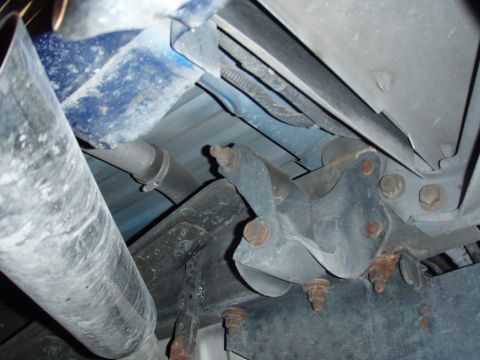 1996 Ford Bronco - Close-up of a vehicle's undercarriage, showing a bracket and exhaust system components.
