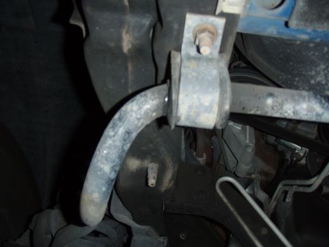 1996 Ford Bronco - Close-up of a vehicle's sway bar assembly, showing the bar and its mounting hardware.