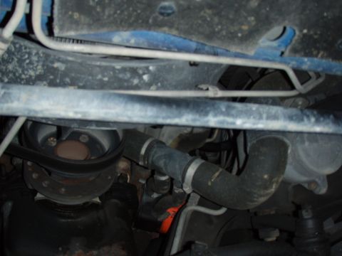 1996 Ford Bronco - A close-up view of the underside of a vehicle, focusing on mechanical components and structural elements.