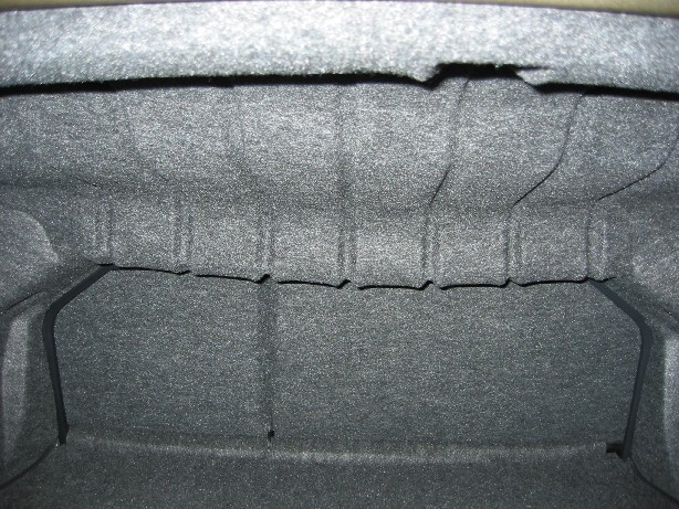 Gray carpeted automobile trunk or cargo area interior close-up