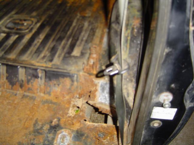 Rusty interior floor and door jamb of a vehicle