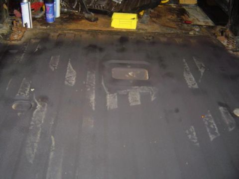 1979 Ford Bronco - The bare metal floor of a vehicle interior shows signs of previous work and preparation for sale items stored items.