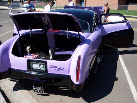 1972 Ford Ranchero - Customized coupe with unique paint scheme and open trunk displaying American flag and dice.