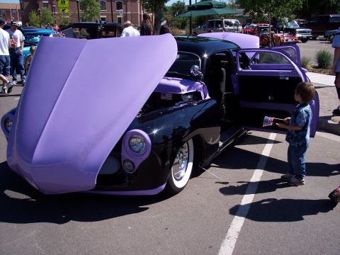 1972 Ford Ranchero - A customized car with its hood and door open, attracting attention at an outdoor event.