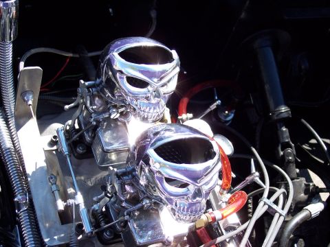 1972 Ford Ranchero - Chrome skull air cleaners adorn the engine of a custom vehicle.
