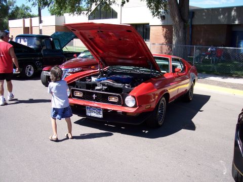 1972 Ford Ranchero - A red 1971 Ford Mustang Mach 1 is displayed with its hood open at an outdoor event.