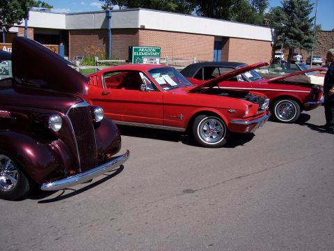 1972 Ford Ranchero - Three classic cars are displayed with their hoods open at an outdoor event.