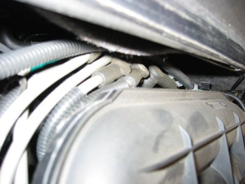 2002 Mercury Sable - Close-up view of engine bay components, including spark plug wires and a textured cover.