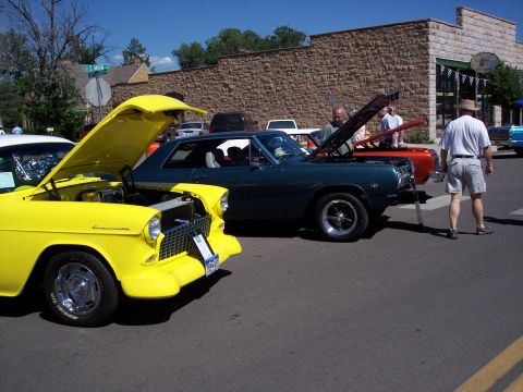 1972 Ford Ranchero - Two classic cars are displayed with their hoods up at an outdoor event.