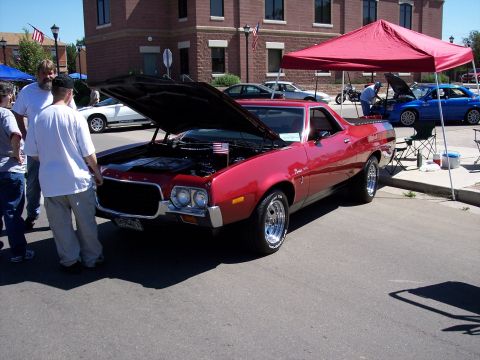 1972 Ford Ranchero - A red 1972 Ford Ranchero is displayed with its hood open at an outdoor event.