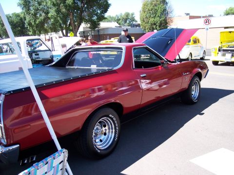 1972 Ford Ranchero - A red 1972 Ford Ranchero is displayed with its hood open, alongside other vehicles.