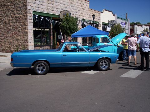 1972 Ford Ranchero - Two classic vehicles, a blue El Camino and a light blue pickup, are displayed with their hoods open.