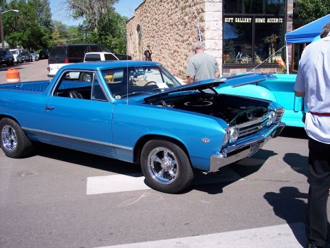 1972 Ford Ranchero - A bright blue El Camino is displayed with its hood up, parked on a street next to another vehicle.