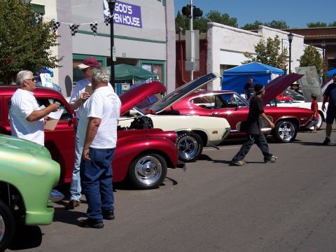 1972 Ford Ranchero - Several classic cars are on display at an outdoor event with people milling around.