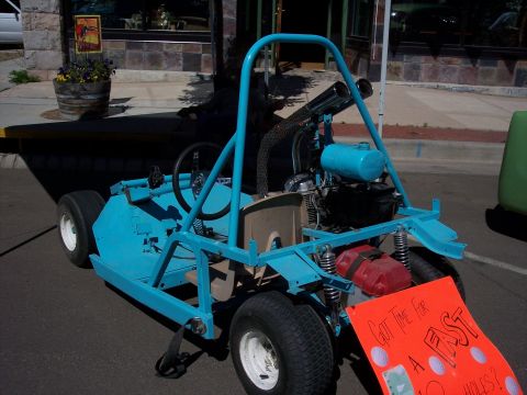 1972 Ford Ranchero - A custom blue go-kart with a roll cage and dual exhaust pipes is parked on a street.