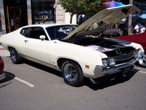 1972 Ford Ranchero - A classic Ford Torino GT is displayed with its hood open at an outdoor event.