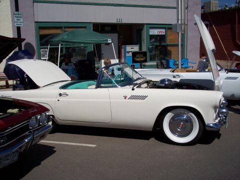 1972 Ford Ranchero - A white 1957 Ford Thunderbird convertible is parked with its hood open, showing the engine bay.