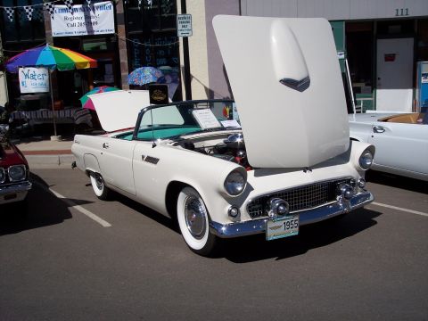 1972 Ford Ranchero - A classic white 1955 Ford Thunderbird convertible is displayed with its hood open, revealing the engine.