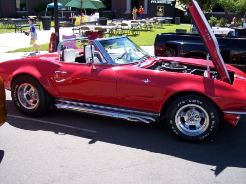 1972 Ford Ranchero - A red 1967 Corvette convertible is displayed with its hood open, revealing the engine and chrome side pipes.