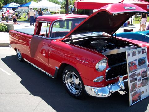 1972 Ford Ranchero - A red 1955 Chevrolet pickup truck is displayed with its hood open, revealing the engine bay.