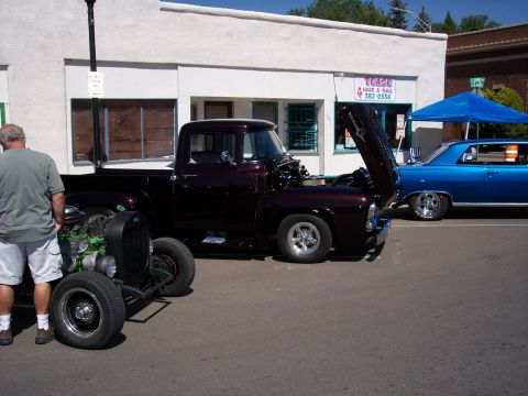 1972 Ford Ranchero - A customized 1956 Ford F-100 pickup truck is displayed with its hood open, alongside other vehicles.