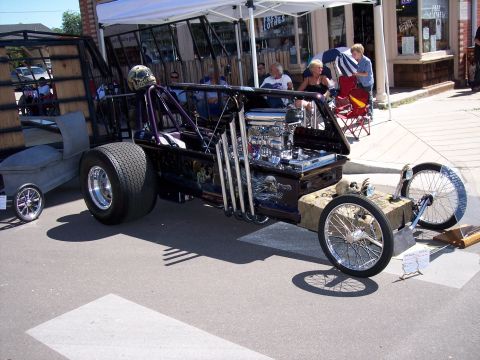 1972 Ford Ranchero - This heavily modified vehicle features extensive skull artwork and a prominent V8 engine.