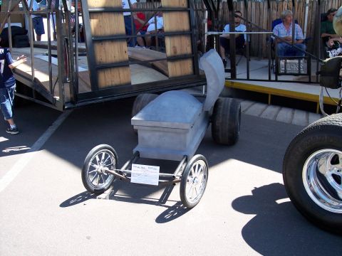 1972 Ford Ranchero - A custom-built vehicle shaped like a coffin is displayed outdoors.