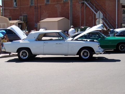 1972 Ford Ranchero - Two classic cars are displayed with their hoods open at an outdoor event.