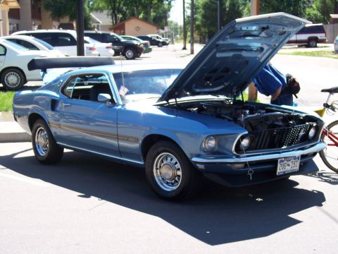 1972 Ford Ranchero - A blue 1969 Ford Mustang Mach 1 is parked with its hood open, revealing the engine compartment.